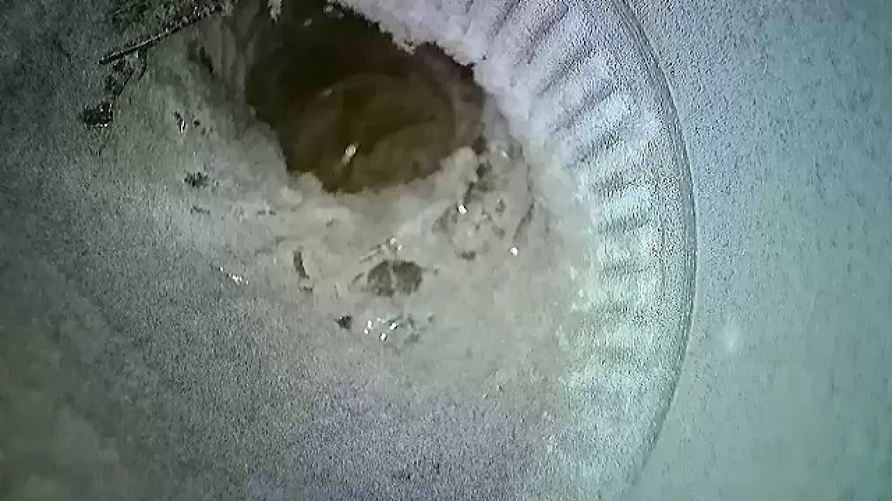 Inspection camera view of clogged duct showing lint obstruction
